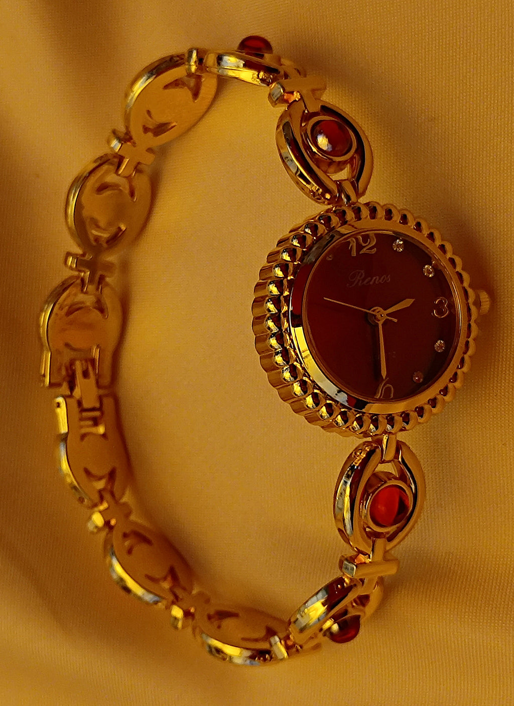 "Ruby" - Elegante Schmuckuhr in Gold mit roten Schmucksteinen