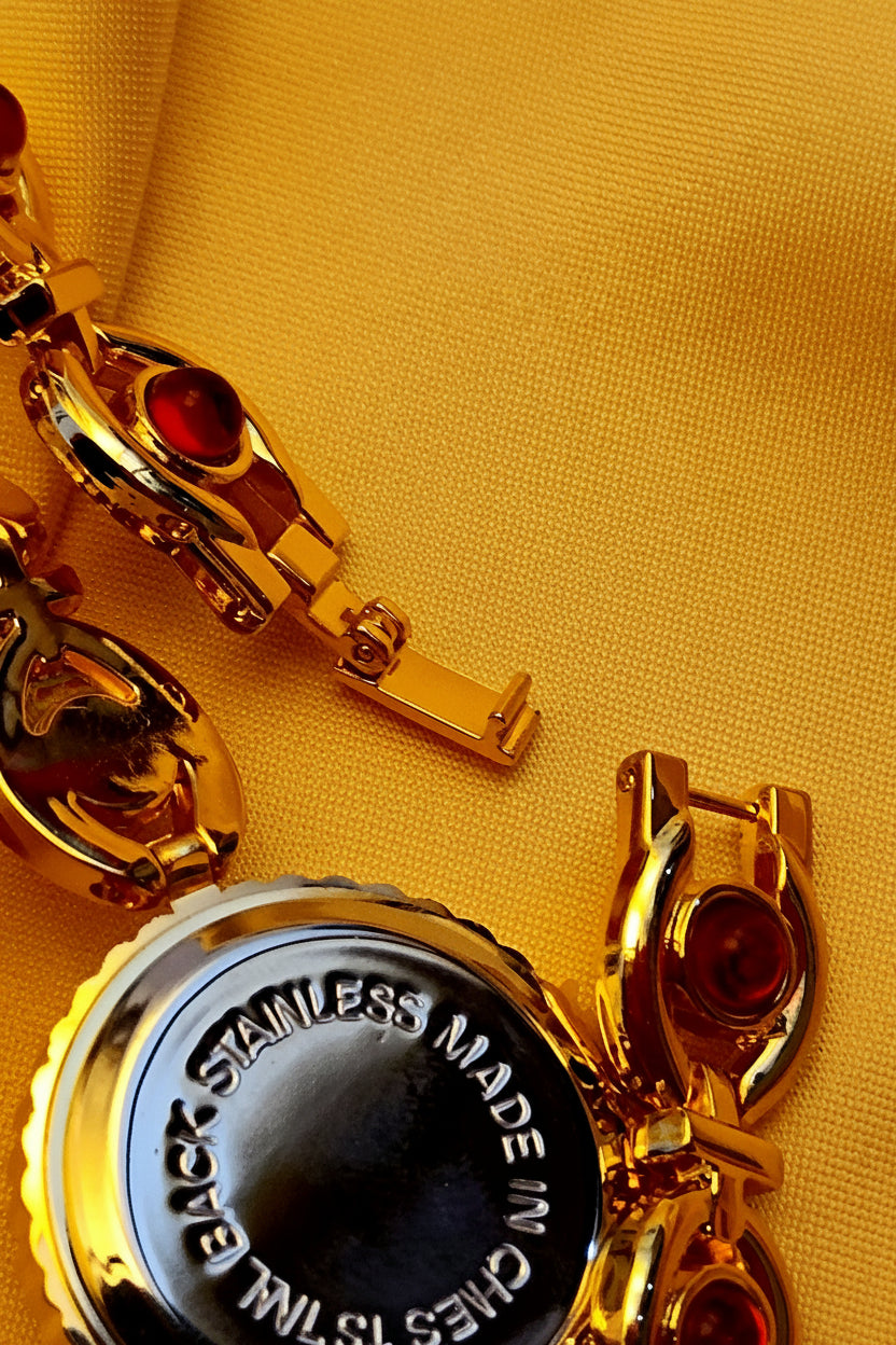"Ruby" - Elegante Schmuckuhr in Gold mit roten Schmucksteinen