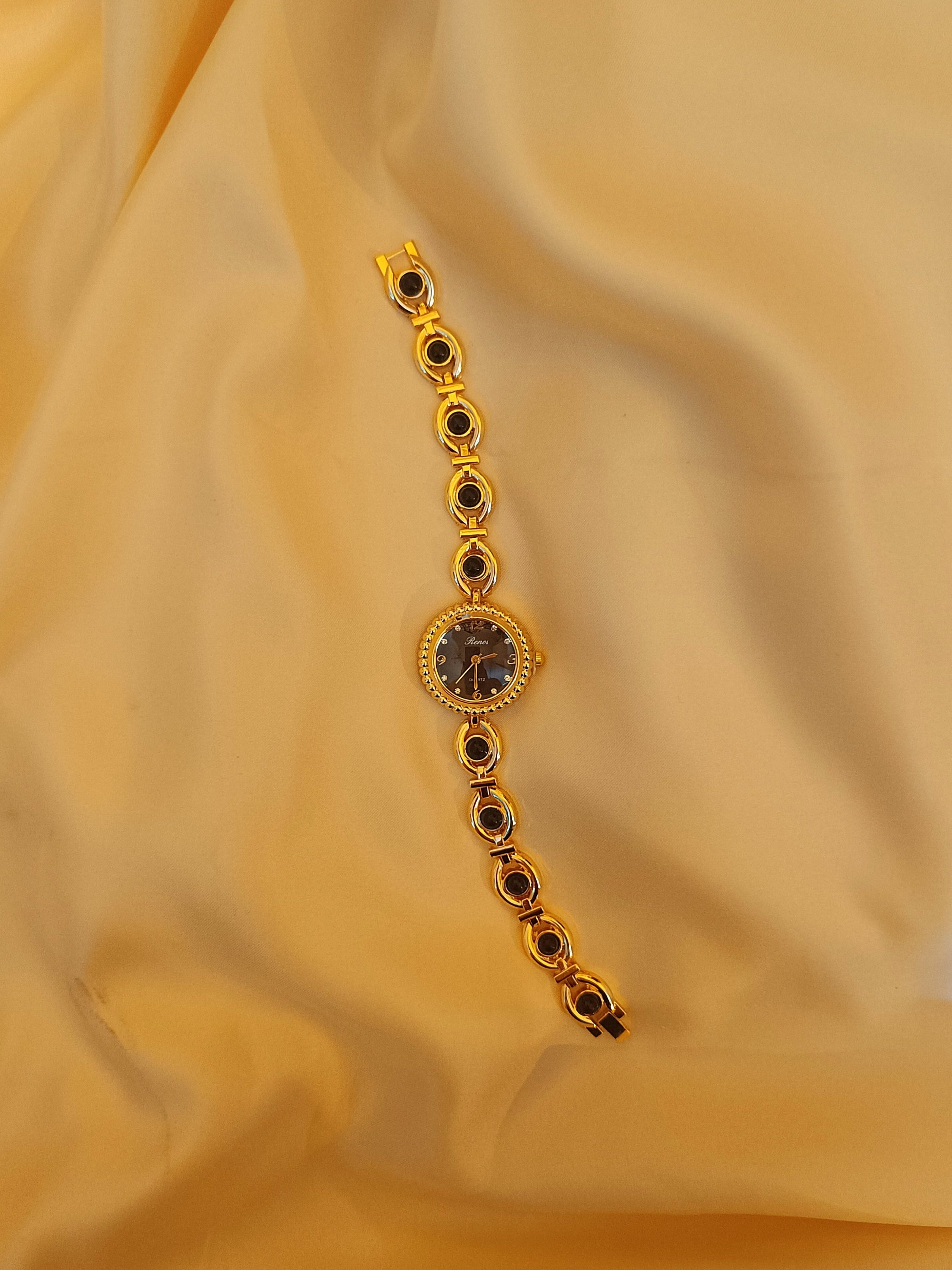 "Ruby" - Elegante Schmuckuhr in Gold mit roten Schmucksteinen