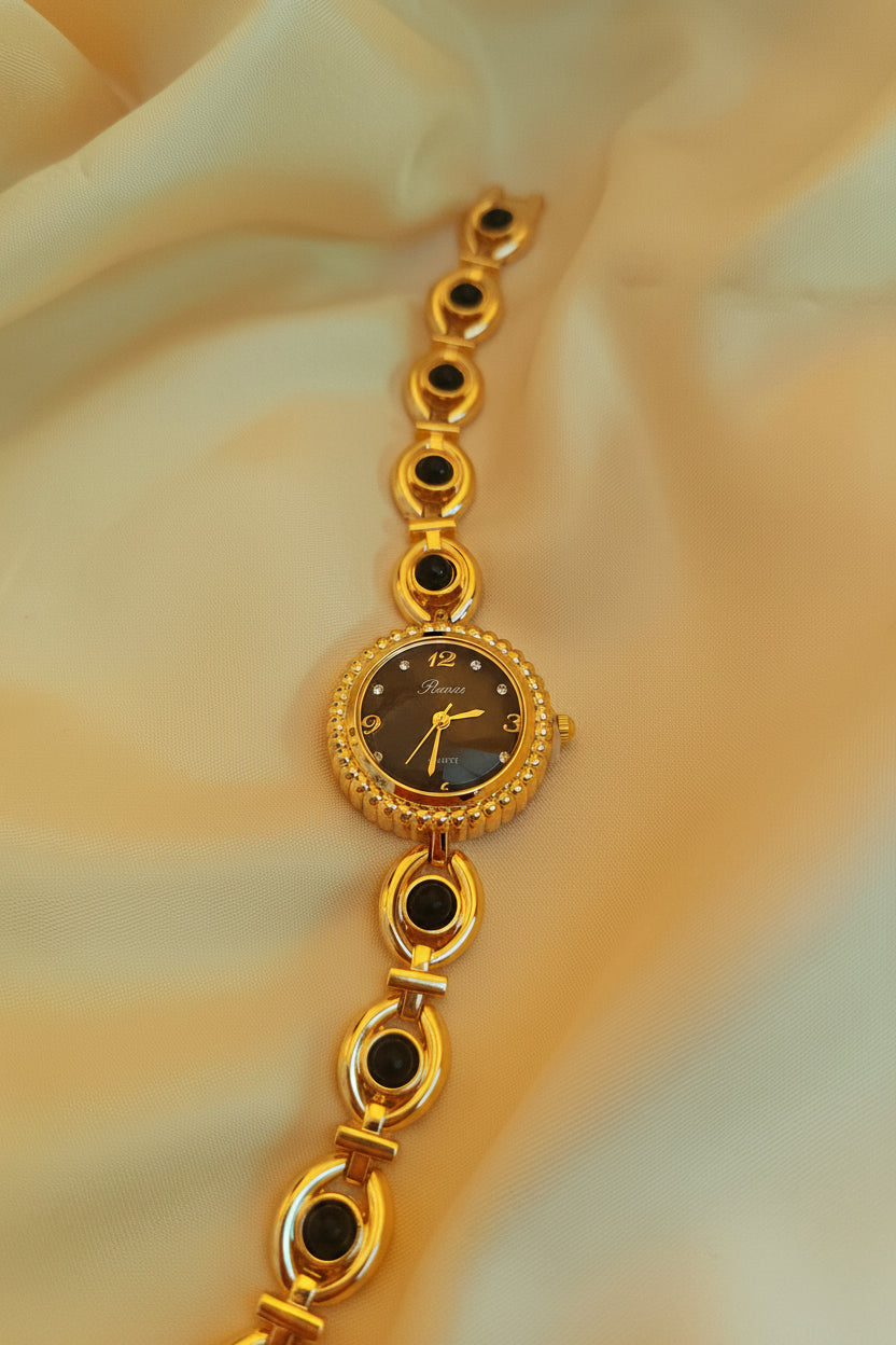 "Ruby" - Elegante Schmuckuhr in Gold mit roten Schmucksteinen